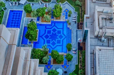 an overhead view of a blue pool in a city at 29 Boulevard Tower 1 Apartment by GLOBALSTAY in Dubai