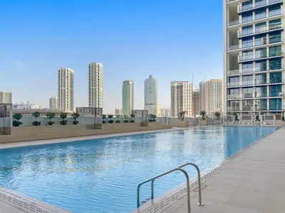 a large swimming pool in a city with tall buildings at Bright 1BR Retreat with Pool Access Near The Palm & Dubai Marina Hotspots in Dubai