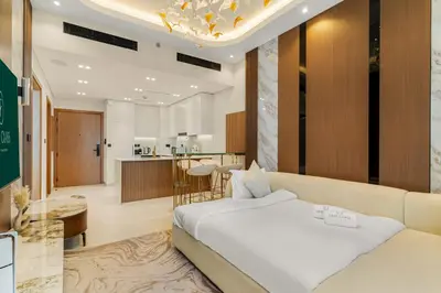 a hotel room with a bed and a kitchen at Bright 1BR Retreat with Pool Access Near The Palm & Dubai Marina Hotspots in Dubai