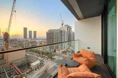 an apartment balcony with a view of a city at Bright 1BR Retreat with Pool Access Near The Palm & Dubai Marina Hotspots in Dubai