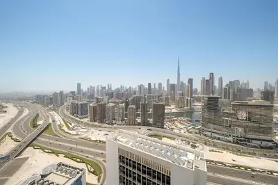 an aerial view of a city with buildings and roads at Luxury 1BR apt with Burj Khalifa, Canal View Pool Gym Near Dubai Mall in Dubai