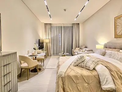 a bedroom with a bed and a living room at Kazan Homes - Lux - Studio Close to Burj Khalifa & Dubai Mall - Business Bay in Dubai