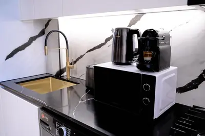 a coffee maker sitting on top of a microwave in a kitchen at Kazan Homes - Lux - Studio Close to Burj Khalifa & Dubai Mall - Business Bay in Dubai