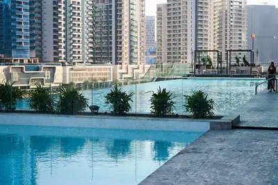 a large swimming pool in a city with tall buildings at Kazan Homes - Lux - Studio Close to Burj Khalifa & Dubai Mall - Business Bay in Dubai