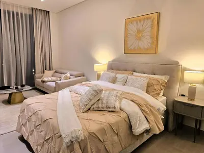 a bedroom with a large bed and a couch at Kazan Homes - Lux - Studio Close to Burj Khalifa & Dubai Mall - Business Bay in Dubai