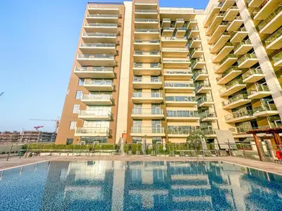 a large building with a swimming pool in front of a building at FIRST CLASS Studio Classy Comfort in Dubai