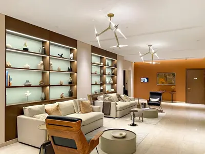 a living room with a couch and chairs and shelves at Elegant 1BR Stay in Sobha Creek Luxury Apartment Near Dubai Canal in Dubai