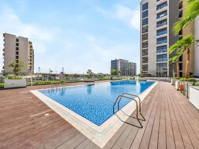 a swimming pool in the middle of a building at Heaven Crest Vacation Homes - One Bedroom City View Balcony in Azizi Riviera in Dubai