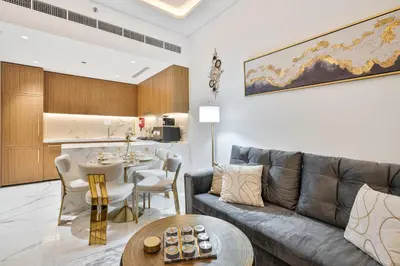 a living room with a couch and a table at Heaven Crest Vacation Homes - One Bedroom City View Balcony in Azizi Riviera in Dubai