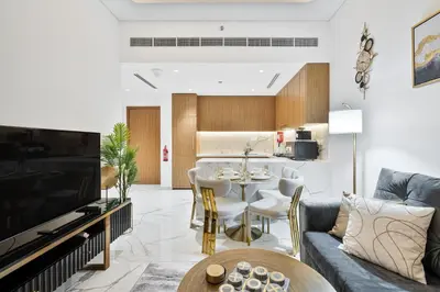 a living room with a couch and a table at Heaven Crest Vacation Homes - One Bedroom City View Balcony in Azizi Riviera in Dubai
