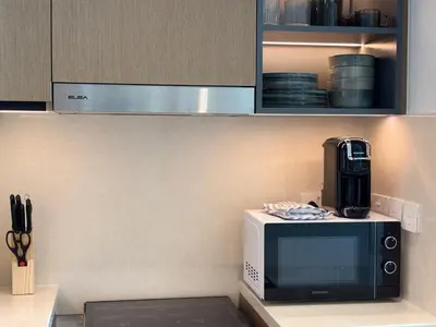 a microwave sitting on a counter in a kitchen at Emaar Burj Crown - 1BR Sea View across from Burj Khalifa, walk to Dubai Mall in Dubai