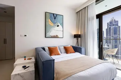 a bedroom with a bed and a large window at Emaar Burj Crown - 1BR Sea View across from Burj Khalifa, walk to Dubai Mall in Dubai