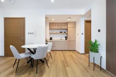 a dining room with a table and white chairs at Elite apartment near Dubai Mall in Dubai