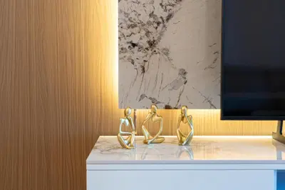 two gold sculptures sitting on a counter in a room at Elite apartment near Dubai Mall in Dubai