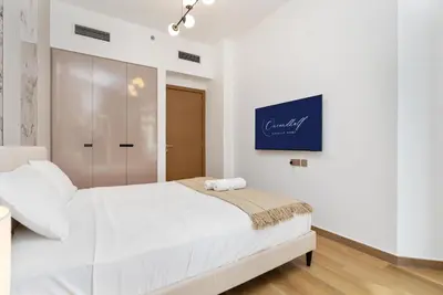 a white bedroom with a large white bed in it at Elite apartment near Dubai Mall in Dubai