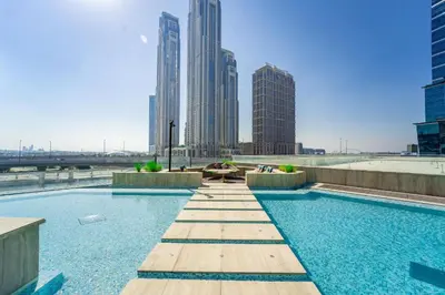 a swimming pool in a city with tall buildings at Elite apartment near Dubai Mall in Dubai