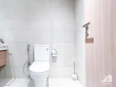 a white bathroom with a toilet and a shower at Luxury Living in Azizi Riviera l Cozy Balcony in Dubai
