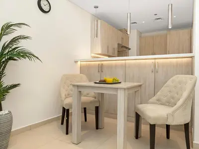 a kitchen with a table and two chairs at Palm Jumeirah Beachfront 1 Bedroom Apartment with Rooftop Infinity Pool and Atlantis Views in Dubai