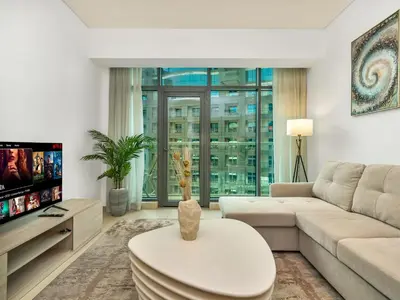 a living room with a couch and a table at Palm Jumeirah Beachfront 1 Bedroom Apartment with Rooftop Infinity Pool and Atlantis Views in Dubai