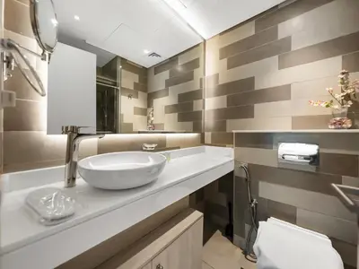 a bathroom with a sink and a mirror at Palm Jumeirah Beachfront 1 Bedroom Apartment with Rooftop Infinity Pool and Atlantis Views in Dubai