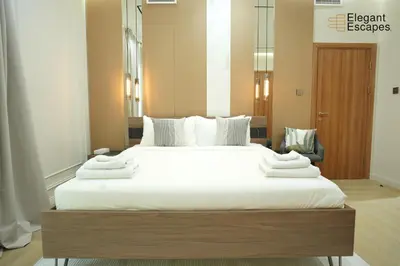 a bedroom with a large bed with white sheets at Stylish 1B in Heart of Marina Near Attractions in Dubai