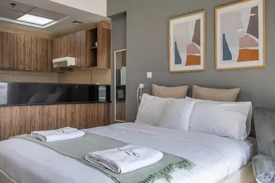 a bedroom with a large bed with towels on it at Burj Nujoom I Studio I Downtown in Dubai