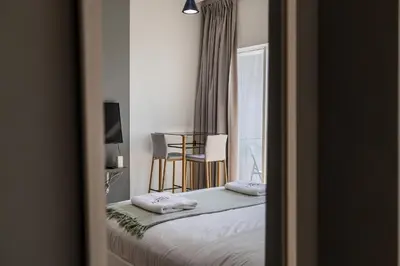 a bedroom with a bed with two pillows on it at Burj Nujoom I Studio I Downtown in Dubai