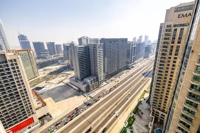 an aerial view of a busy city with traffic at Burj Nujoom I Studio I Downtown in Dubai