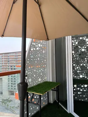 a table under an umbrella on a balcony at Millennium Binghatti Studio I Business bay I Studio in Dubai