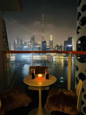 a table on a balcony with a view of a city at Millennium Binghatti Studio I Business bay I Studio in Dubai