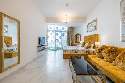 a living room with a couch and a mirror at Millennium Binghatti Studio I Business bay I Studio in Dubai