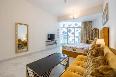 a living room with a couch and a bed and a mirror at Millennium Binghatti Studio I Business bay I Studio in Dubai