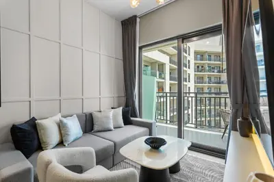 a living room with a couch and a large window at Sleek 1-Bedroom Getaway in Zada Tower in Dubai