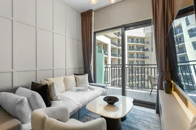 a living room with a couch and a table at Sleek 1-Bedroom Getaway in Zada Tower in Dubai