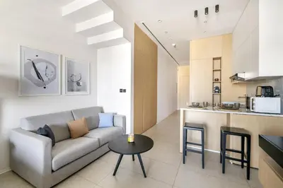 a living room with a couch and a table at VayK - Great Escape at Anantara The Palm Residences in Dubai