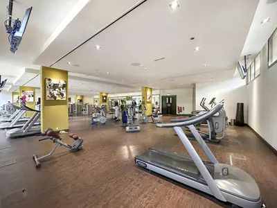 a gym with several treadmills and exercise bikes at VayK - Great Escape at Anantara The Palm Residences in Dubai