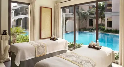 two beds in a room with a swimming pool at VayK - Great Escape at Anantara The Palm Residences in Dubai