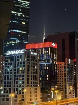 a view of a city at night with buildings at Enjoy our feel-home Appartement in Dubai