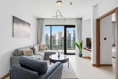 a living room with a couch and a table at VayK - Sleek & Stylish 1BR in Vida Dubai Marina in Dubai