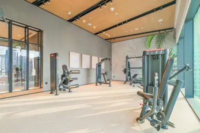 a gym with treadmills and elliptical machines at VayK - Sleek & Stylish 1BR in Vida Dubai Marina in Dubai
