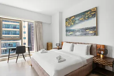 a bedroom with a large bed and a large window at VayK - Premium 2BR Stay in Dubai Marina in Dubai