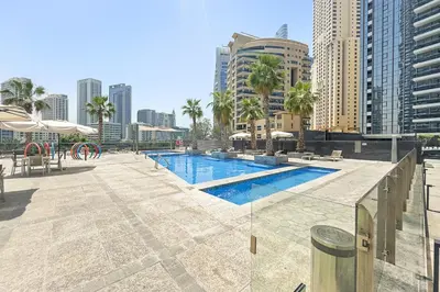a swimming pool in a city with tall buildings at VayK - Premium 2BR Stay in Dubai Marina in Dubai