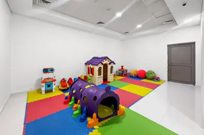 a room with a play room with a play set at VayK - Premium 2BR Stay in Dubai Marina in Dubai