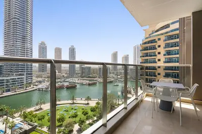 a balcony with a view of a river and buildings at VayK - Premium 2BR Stay in Dubai Marina in Dubai