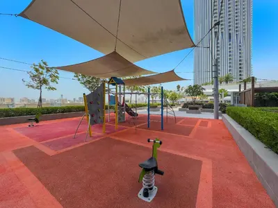 a playground with a skateboard under an umbrella at Vayk - Bright & Elegant 2BR Apartment with Creek Views in Dubai