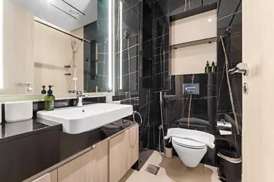 a bathroom with a white sink and a toilet at VayK - Comfortable Studio in JLT with Amazing Amenities in Dubai