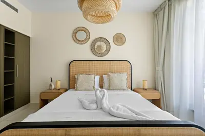 a bedroom with a large bed with a white bedspread at VayK - Modern 1BR apartment in the Heart of Downtown Dubai in Dubai