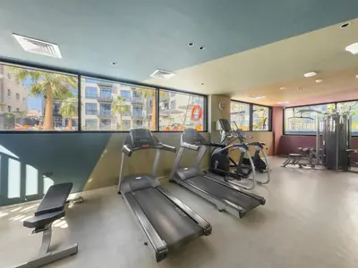 a gym with treadmills and ellipticals in a building at VayK - Contemporary and Cozy Studio in the Heart of JVC in Dubai