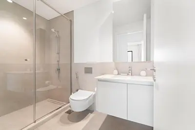 a bathroom with a toilet and a sink and a shower at VayK - Stunning 1BR with Breathtaking Views in Dubai