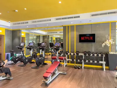 a gym with a lot of treadmills and weights at VayK - Modern 1BR Apartment in Business Bay in Dubai